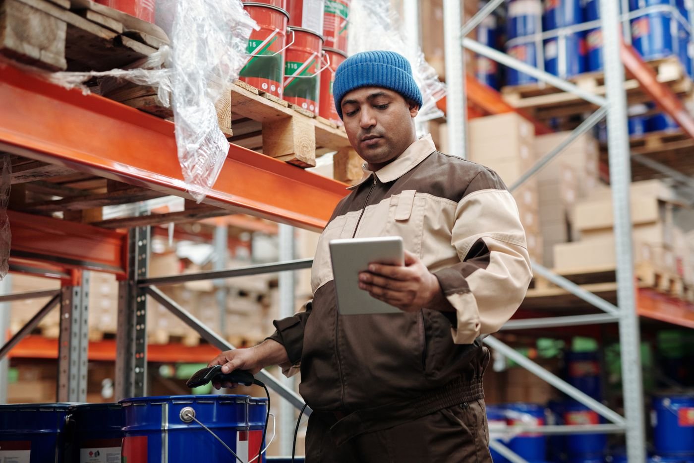 Stock worker checking inventory records on a tablet